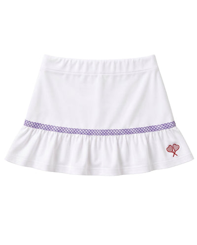 A white ruffled skirt with a purple gingham pattern band around the waist and a small red embroidered heart tennis rackets crossed motif on the lower right side, shown against a plain white background.